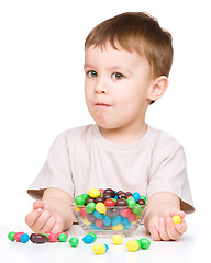 Image showing Portrait of a boy with candies