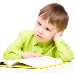 Image showing Little child play with book