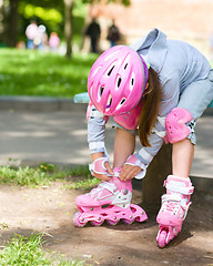 Image showing Little girl is wearing roller-blades