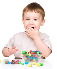 Image showing Portrait of a boy with candies