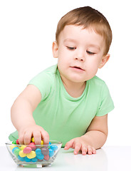 Image showing Portrait of a boy with candies