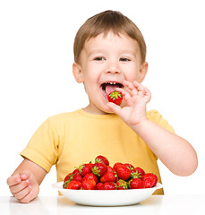 Image showing Happy little boy with strawberries