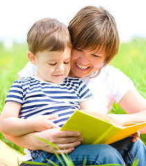 Image showing Mother is reading book for her child