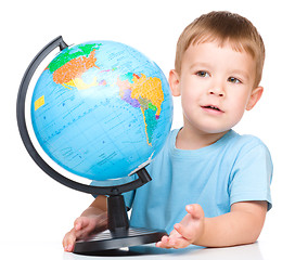 Image showing Happy little boy with a globe