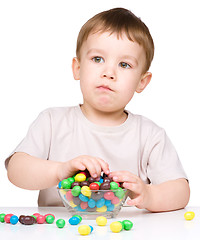 Image showing Portrait of a boy with candies