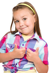 Image showing Little girl is showing thumb up gesture