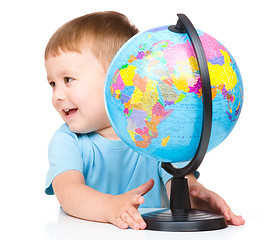 Image showing Happy little boy with a globe