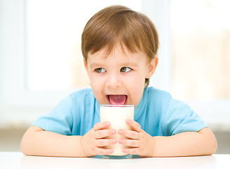 Image showing Cute little boy with a glass of milk