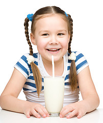 Image showing Cute little girl with a glass of milk