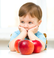 Image showing Portrait of a sad little boy with apples