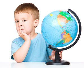 Image showing Little boy with a globe