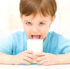 Image showing Cute little boy with a glass of milk