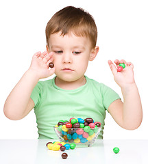 Image showing Portrait of a boy with candies