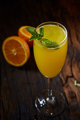 Image showing Orange cocktail on rustic wooden table