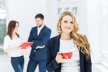 Image showing Young colleagues having coffee break in office