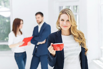 Image showing Young colleagues having coffee break in office