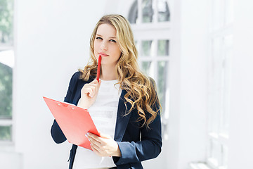 Image showing The female worker against office