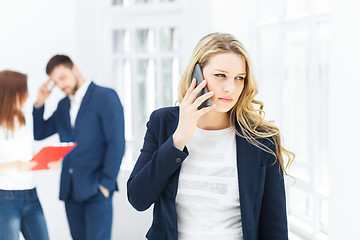 Image showing Portrait of businesswoman talking on phone in office