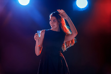 Image showing The beautiful girl dancing at the party drinking champagne