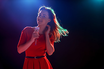 Image showing The beautiful girl dancing at the party drinking champagne