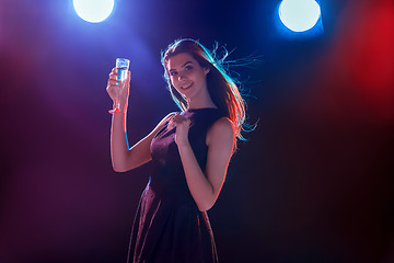 Image showing The beautiful girl dancing at the party drinking champagne