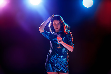 Image showing The beautiful girl dancing at the party drinking champagne