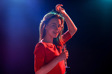 Image showing The beautiful girl dancing at the party drinking champagne