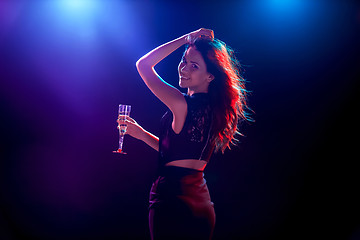 Image showing The beautiful girl dancing at the party drinking champagne