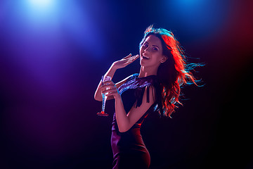 Image showing The beautiful girl dancing at the party drinking champagne