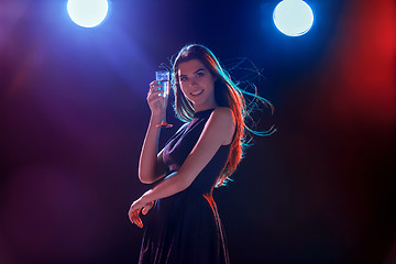 Image showing The beautiful girl dancing at the party drinking champagne