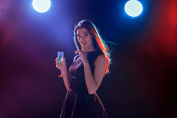 Image showing The beautiful girl dancing at the party drinking champagne