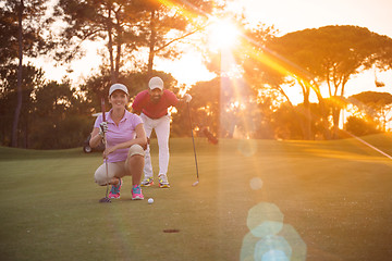 Image showing couple on golf course at sunset