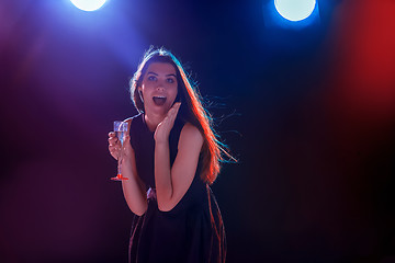 Image showing The beautiful girl dancing at the party drinking champagne