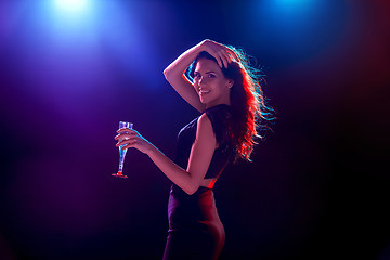Image showing The beautiful girl dancing at the party drinking champagne