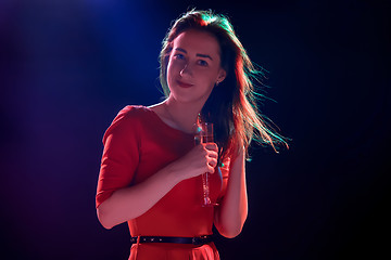 Image showing The beautiful girl dancing at the party drinking champagne