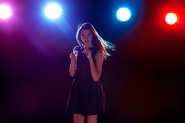 Image showing The beautiful girl dancing at the party drinking champagne