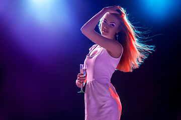 Image showing The beautiful girl dancing at the party drinking champagne