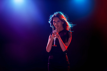 Image showing The beautiful girl dancing at the party drinking champagne