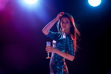 Image showing The beautiful girl dancing at the party drinking champagne