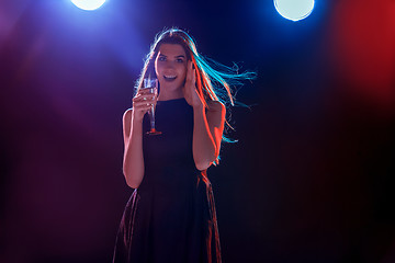 Image showing The beautiful girl dancing at the party drinking champagne