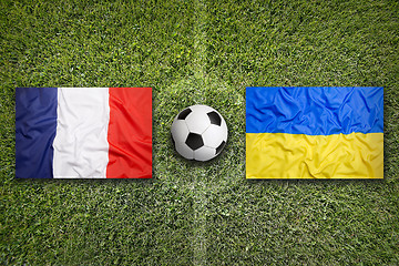 Image showing France vs. Ukraine flags on soccer field