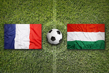 Image showing France vs. Hungary flags on soccer field