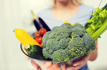 Image showing close up of woman holding vegetables in bowl