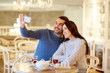 Image showing couple taking smartphone selfie at cafe restaurant