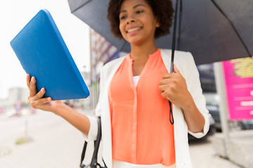 Image showing close up of woman with umbrella and tablet pc