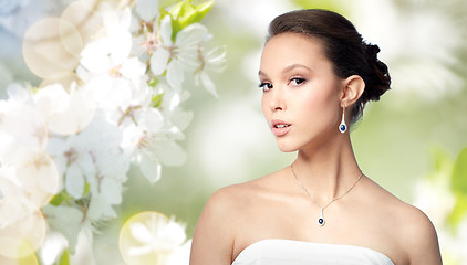 Image showing beautiful asian woman with earring and pendant