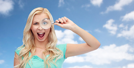 Image showing happy young woman with magnifying glass