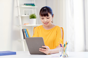 Image showing happy asian woman student with tablet pc at home