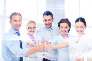 Image showing business team showing thumbs up in office