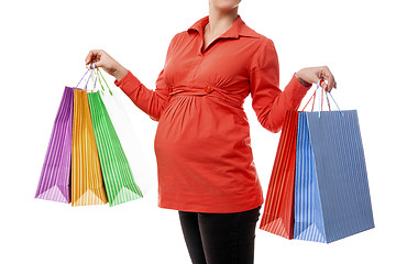 Image showing Pregnant woman holding shopping bags isolated